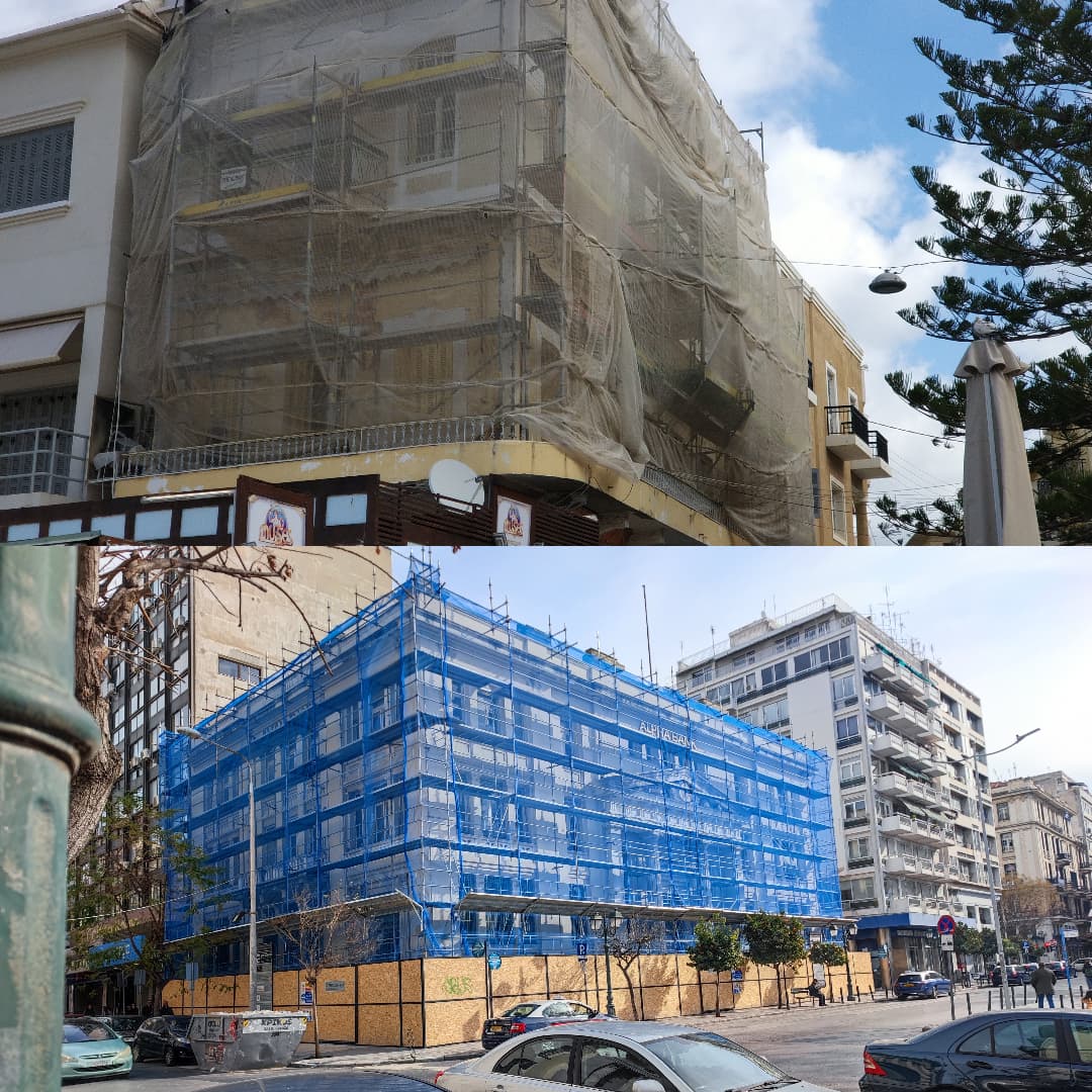 Two city buildings undergoing renovation, wrapped in protective beige and blue construction safety netting.