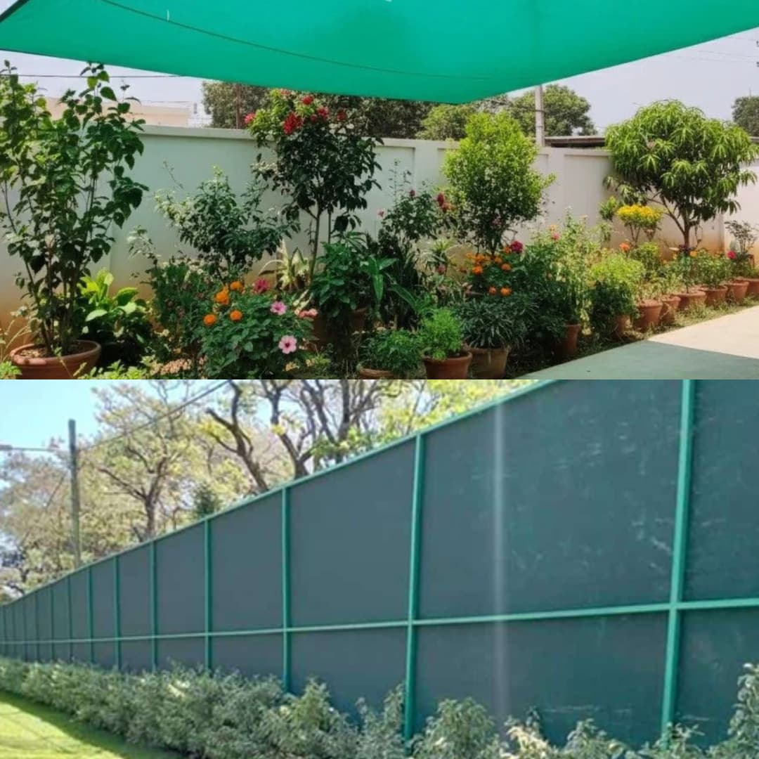 Vibrant garden plants under green shade netting and a tall green mesh privacy fence.